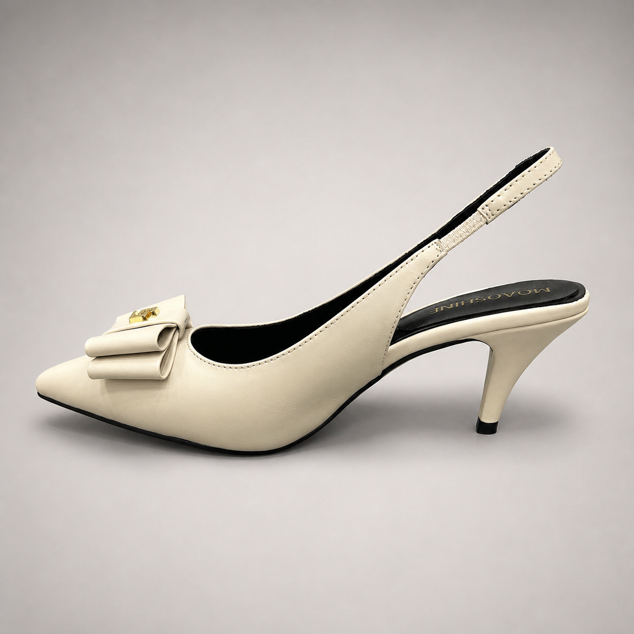Ivory slingback pump opposite side profile showing a pointed toe and bow-shaped vamp ornament