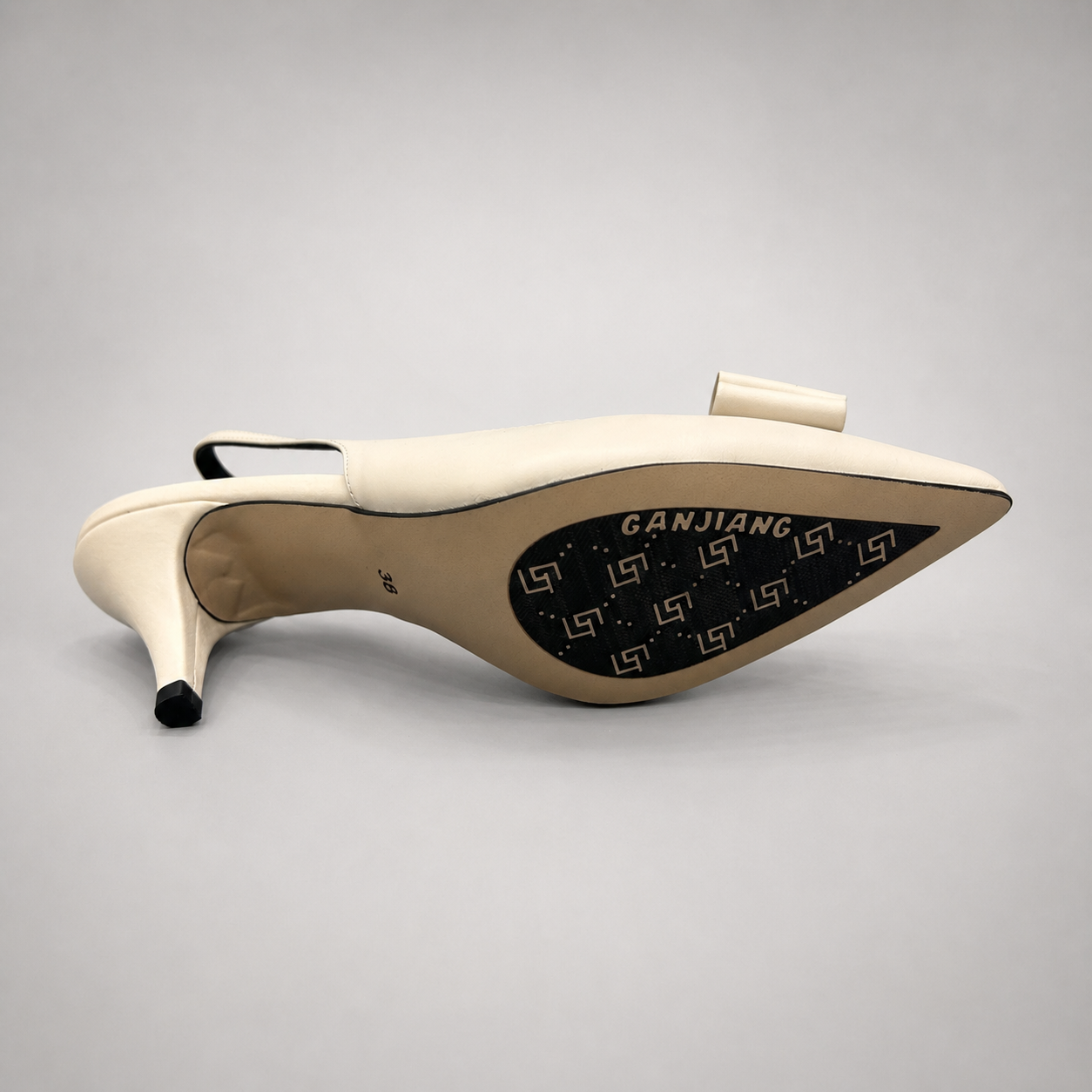 Ivory slingback pump outsole view showing the cow leather outsole