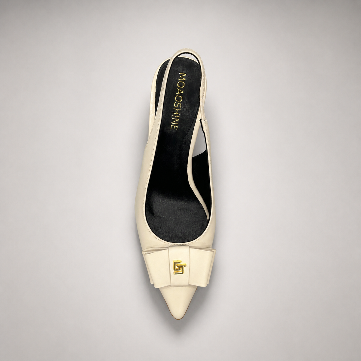 Ivory slingback pump top view showing a pointed toe and bow-shaped vamp ornament