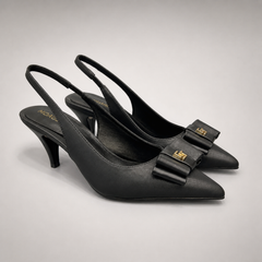 Black slingback pump pair three-quarter view showing a pointed toe and bow-shaped vamp ornament