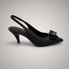 Black slingback pump side profile showing a pointed toe and bow-shaped vamp ornament
