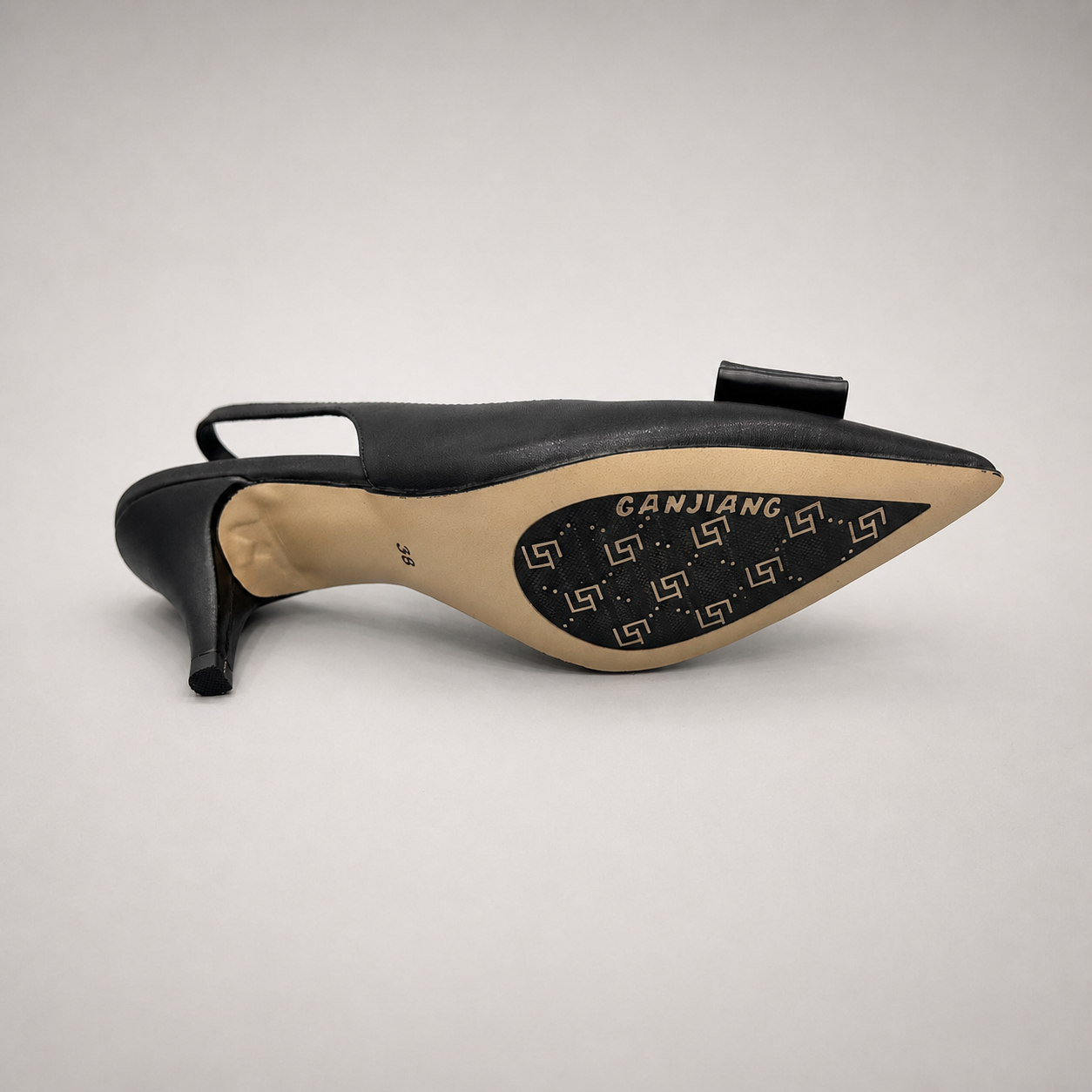 Black slingback pump outsole view showing the cow leather outsole