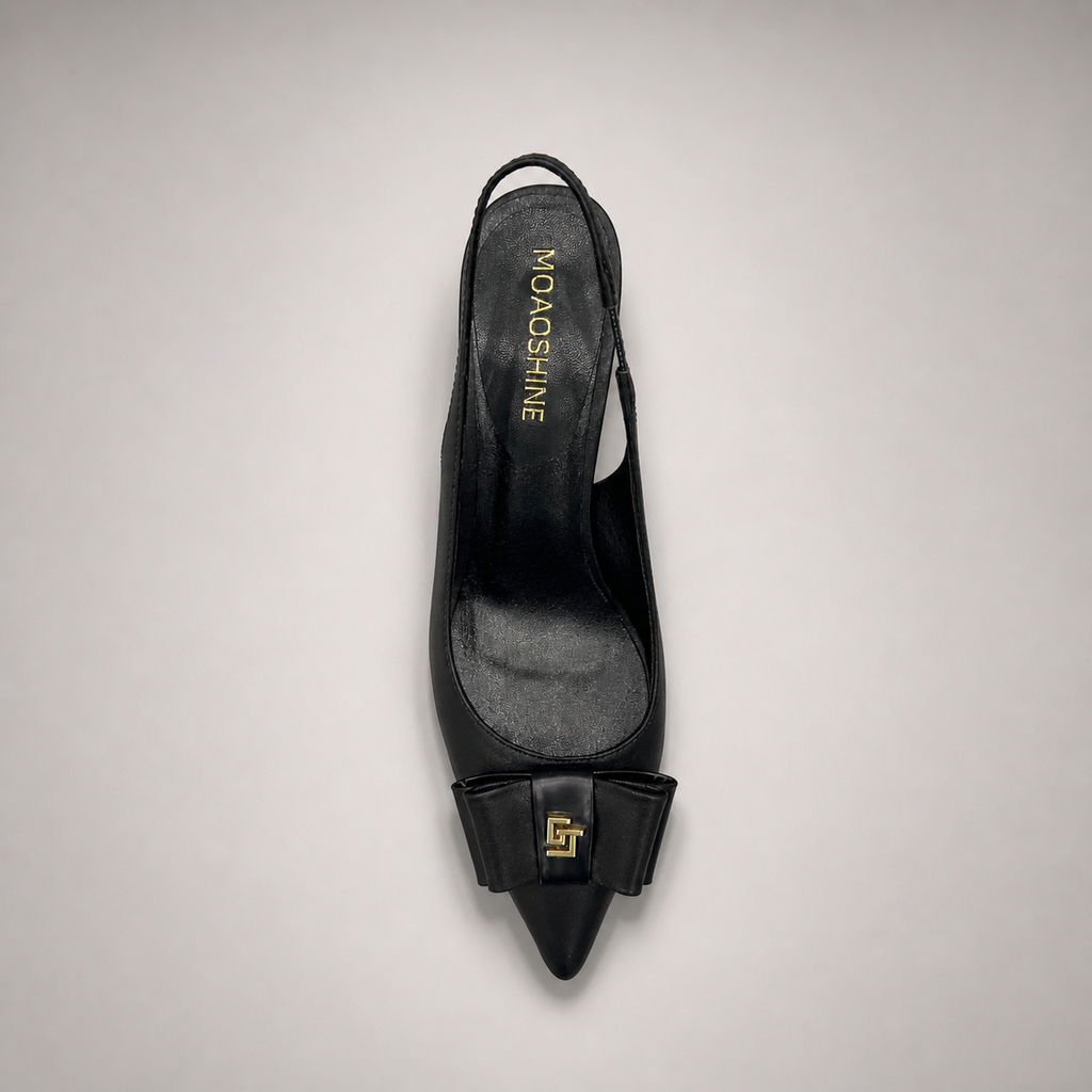 Black slingback pump top view showing a pointed toe and bow-shaped vamp ornament
