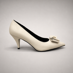 Ivory pump side profile showing a pointed toe and bow-shaped vamp ornament