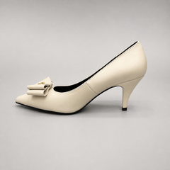 Ivory pump opposite side profile showing a pointed toe and bow-shaped vamp ornament