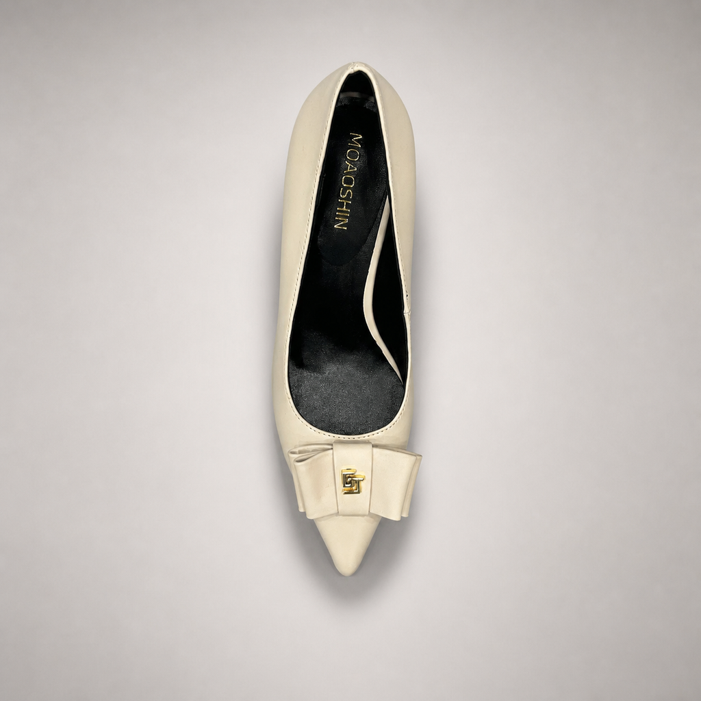 Ivory pump top view showing a pointed toe and bow-shaped vamp ornament