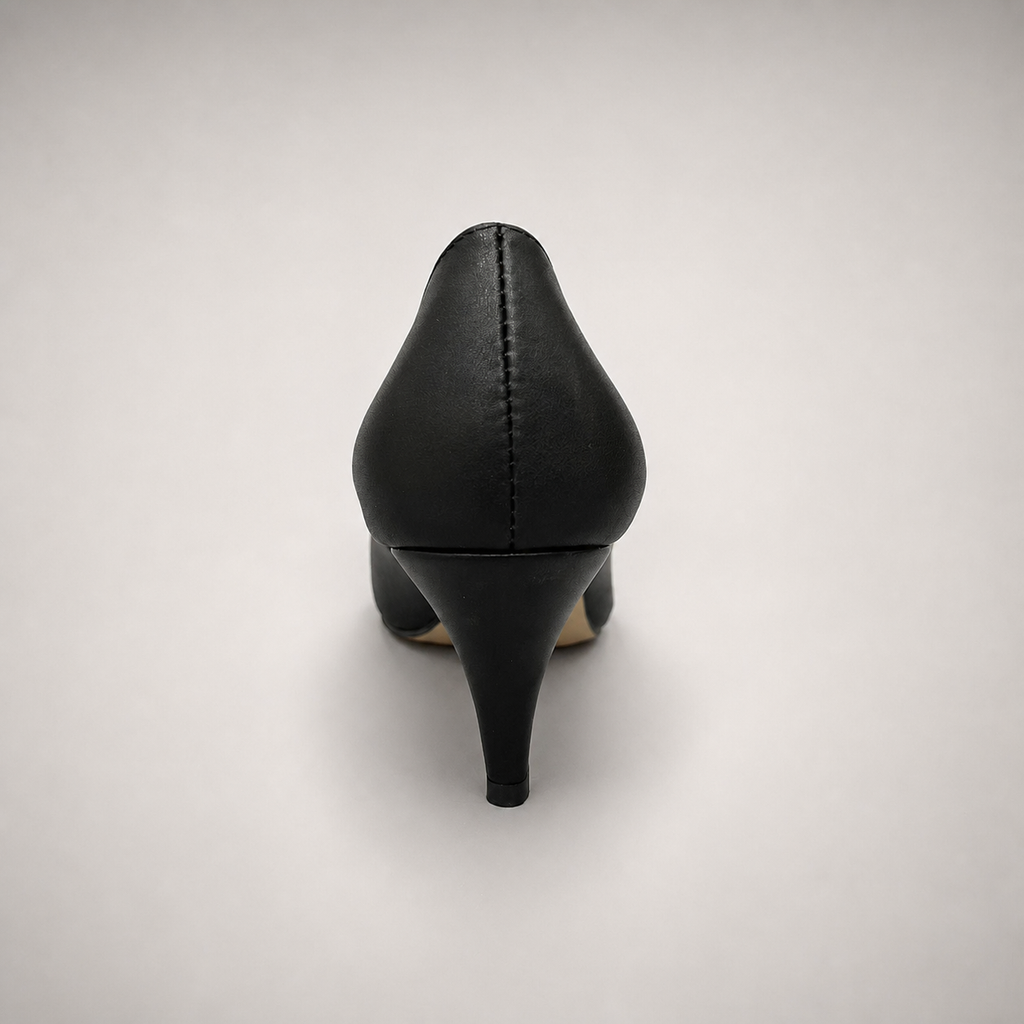 Black pump rear view showing a pointed toe and bow-shaped vamp ornament