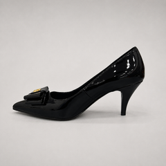 Black pump opposite side profile showing a pointed toe and bow-shaped vamp ornament