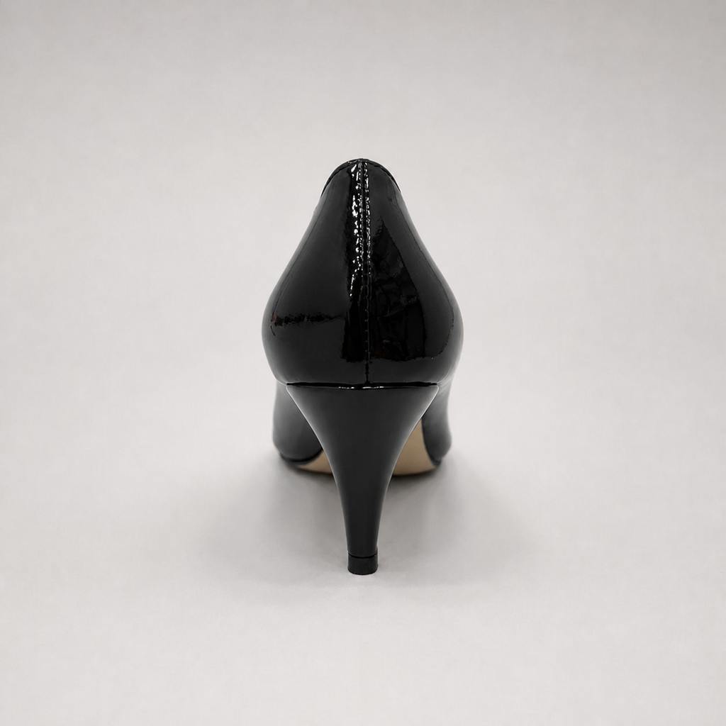Black pump rear view showing a pointed toe and bow-shaped vamp ornament