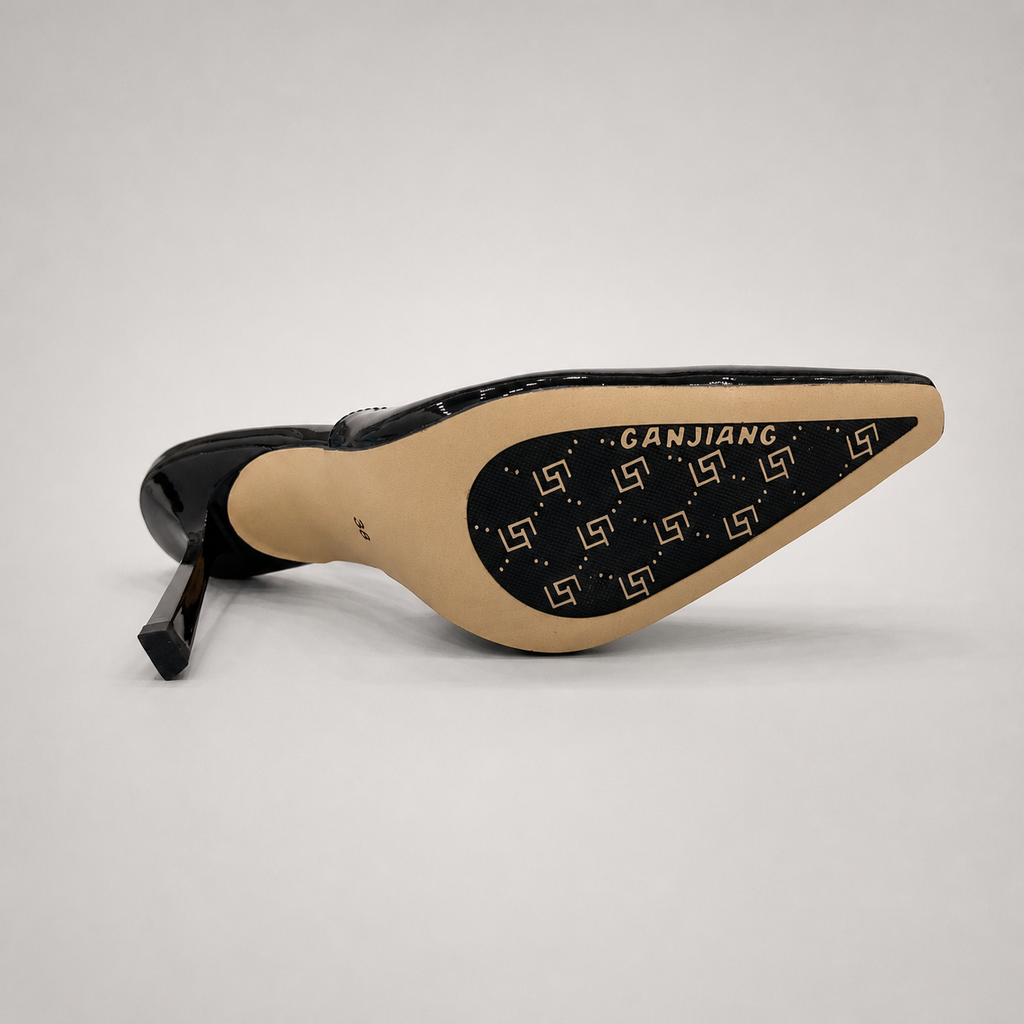 Black slingback pump rear view showing a pointed toe