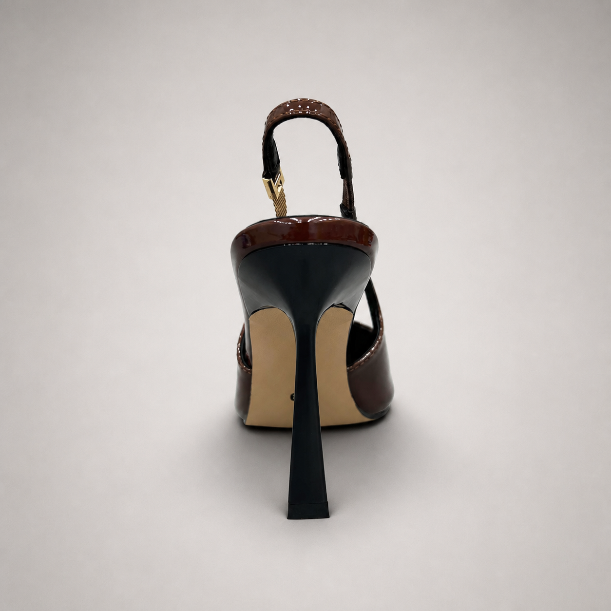 Brown slingback pump rear view showing a pointed toe