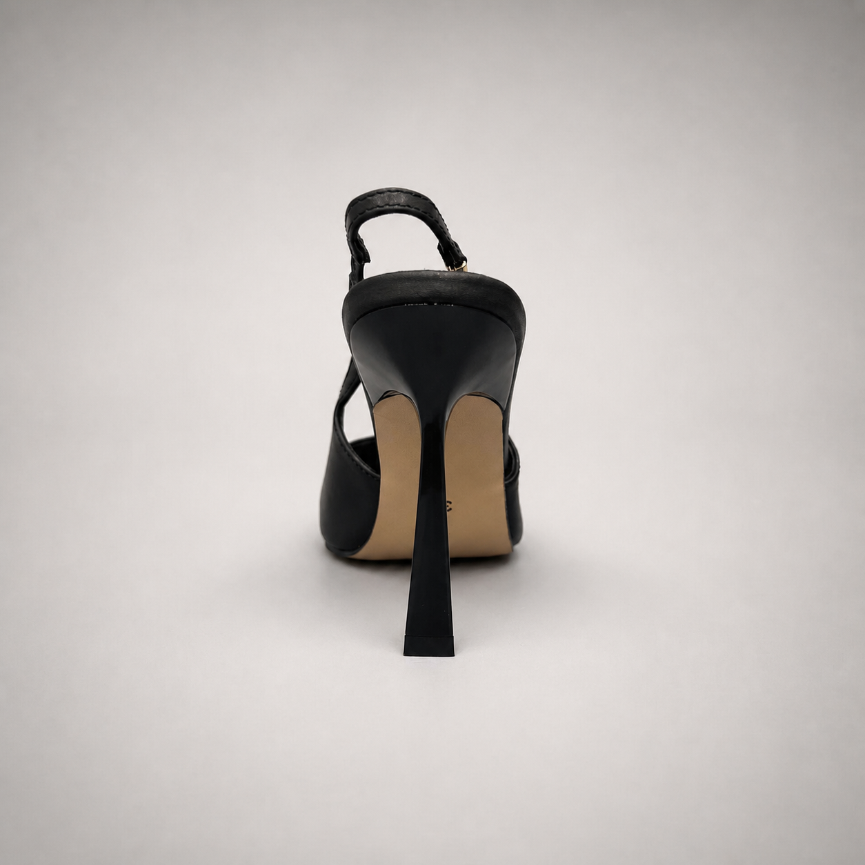 Black slingback pump rear view showing a pointed toe