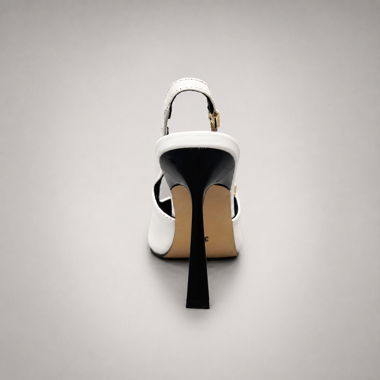 White slingback pump rear view showing a pointed toe and double slingback straps