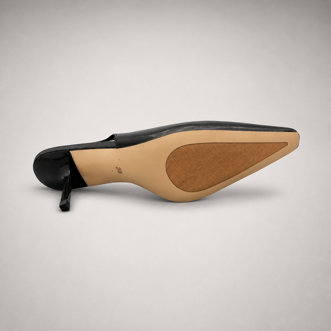 Black slingback pump outsole view showing the cow leather outsole