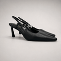 Black slingback pump pair three-quarter view showing a pointed toe and double slingback straps