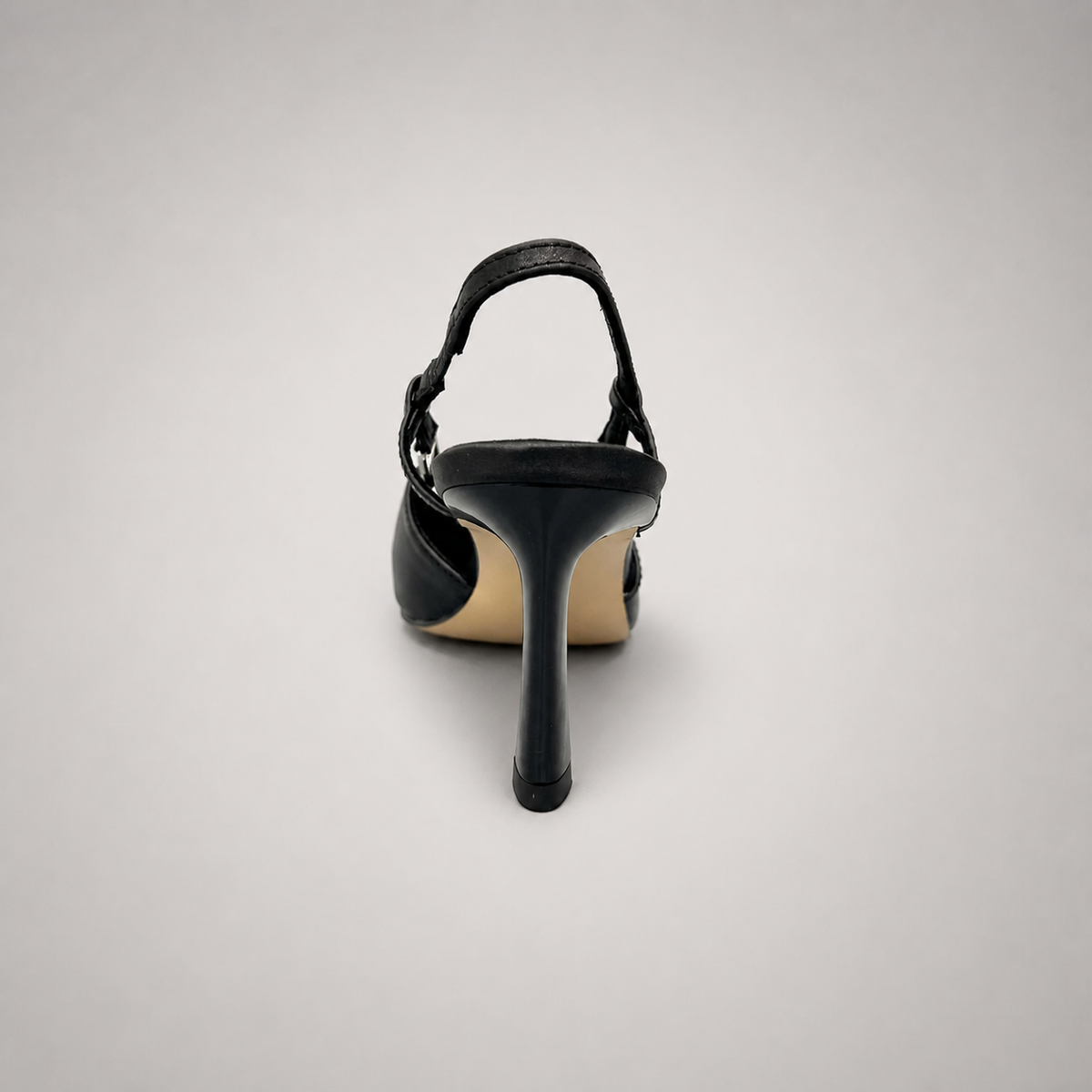 Black slingback pump rear view showing a pointed toe and double slingback straps