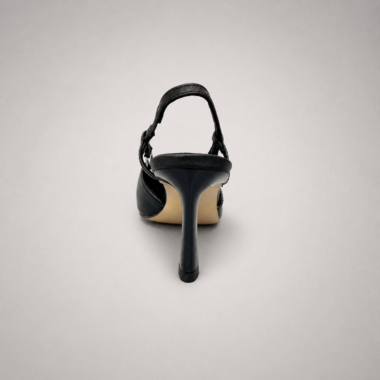 Black slingback pump rear view showing a pointed toe and double slingback straps