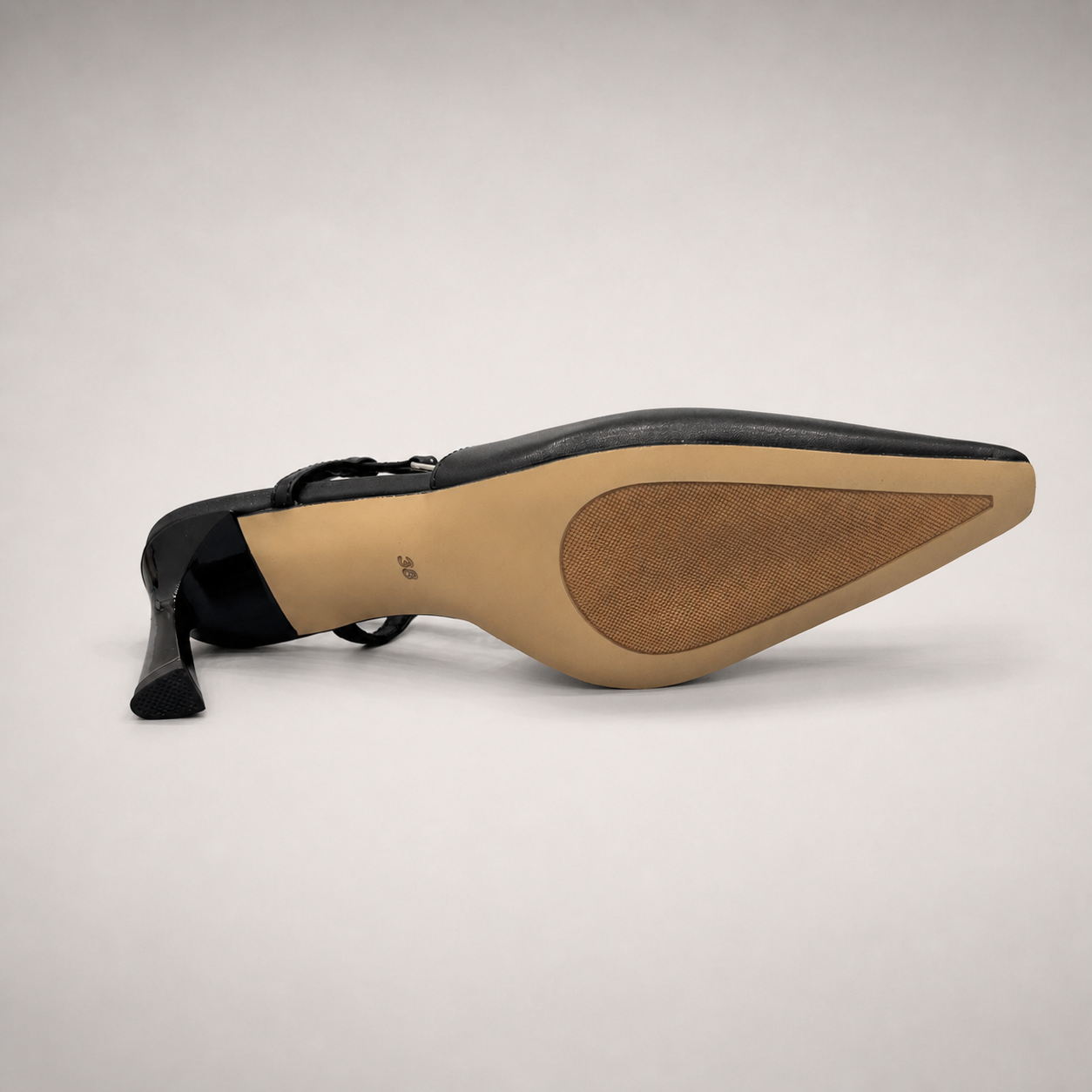 Black slingback pump outsole view showing the cow leather outsole