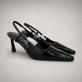 Black slingback pump pair three-quarter view showing a pointed toe and double slingback straps