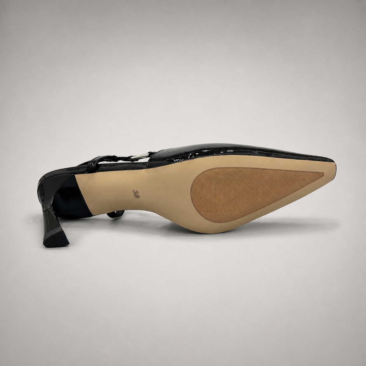 Black slingback pump outsole view showing the cow leather outsole