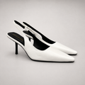 White slingback pump pair three-quarter view showing a pointed toe, angular side cutout, and slingback strap