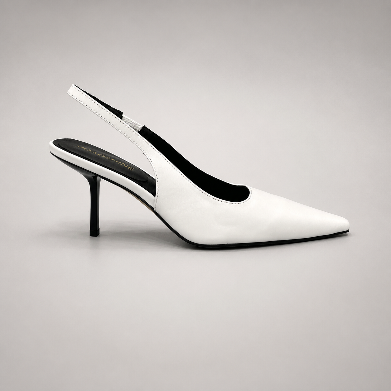 White slingback pump side profile showing a pointed toe, angular side cutout, and slingback strap