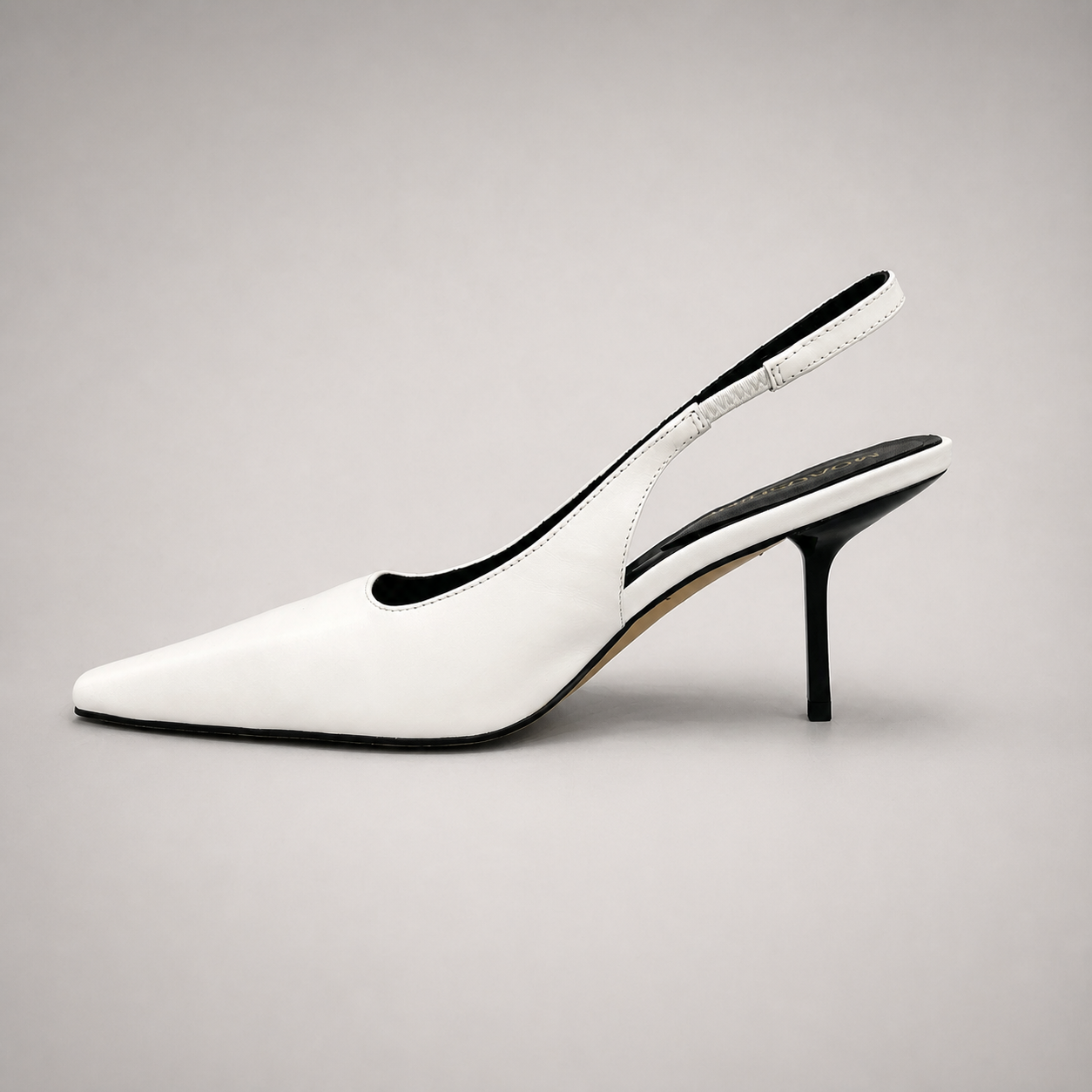 White slingback pump opposite side profile showing a pointed toe, angular side cutout, and slingback strap