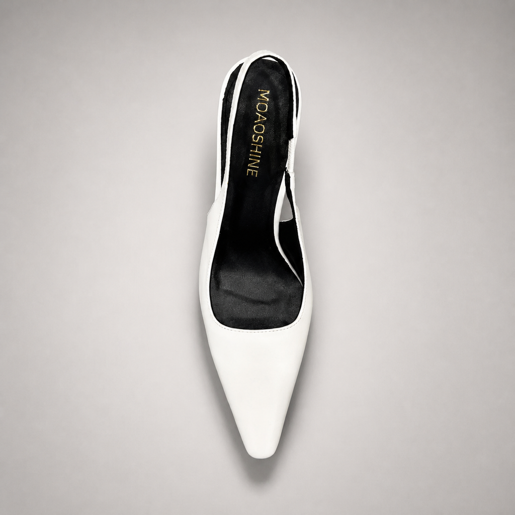 White slingback pump top view showing a pointed toe, angular side cutout, and slingback strap