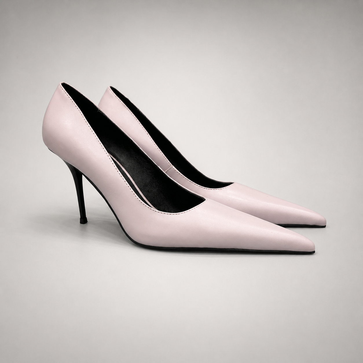 Pink pump pair three-quarter view showing a pointed toe