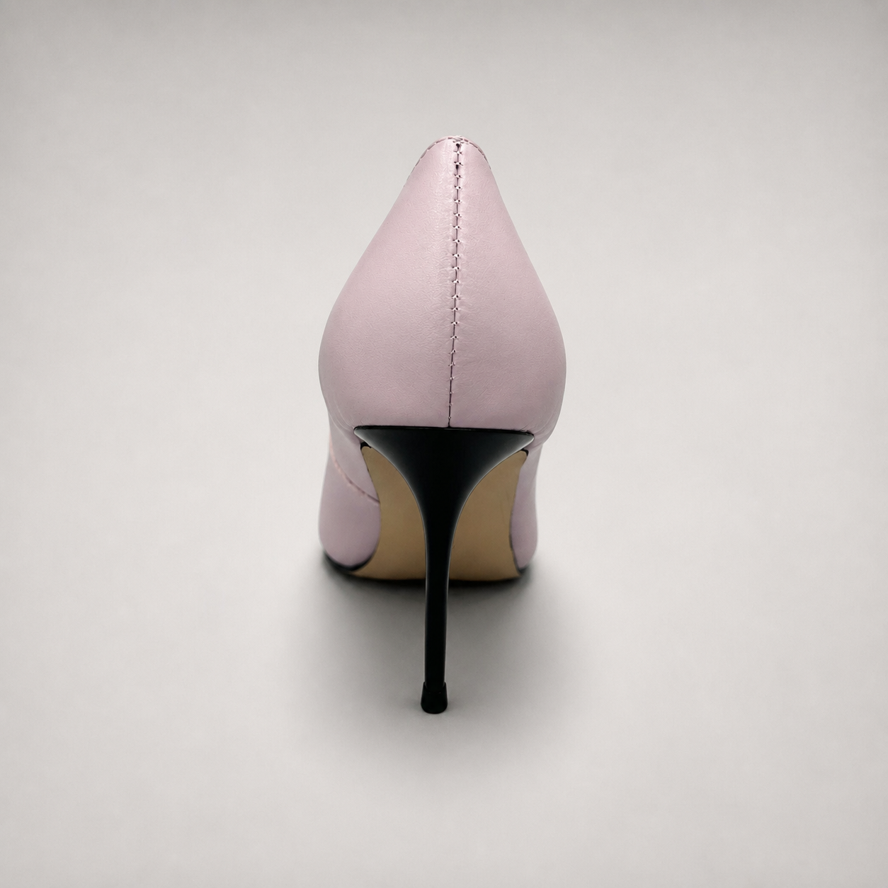 Pink pump rear view showing a pointed toe