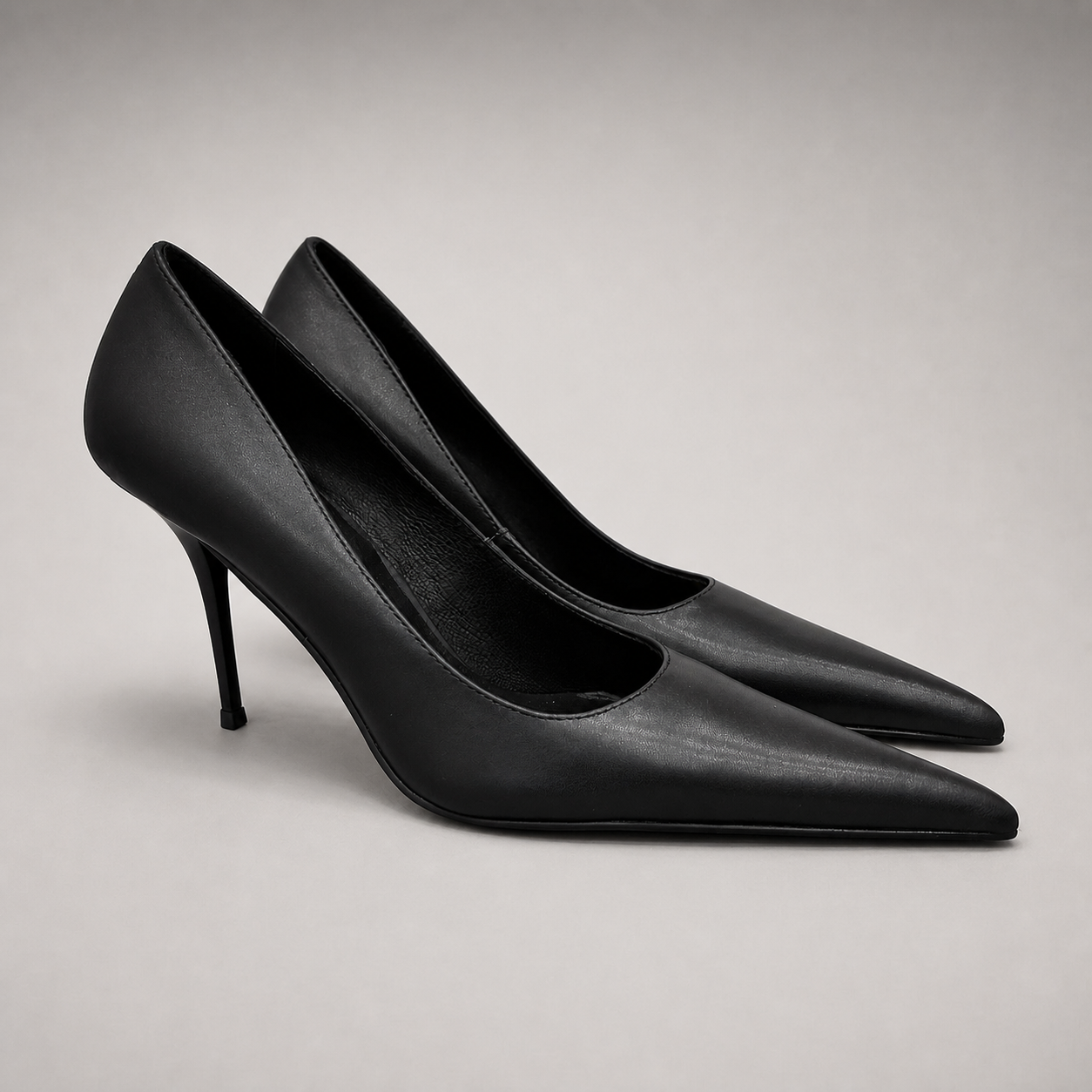 Black pump pair three-quarter view showing a pointed toe