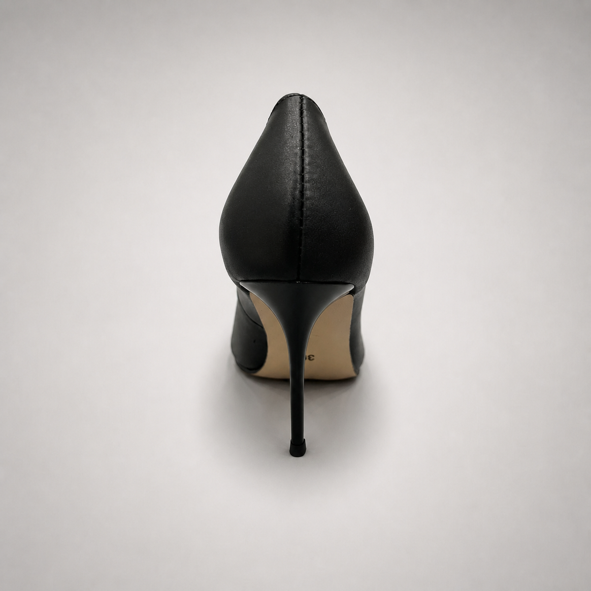 Black pump rear view showing a pointed toe