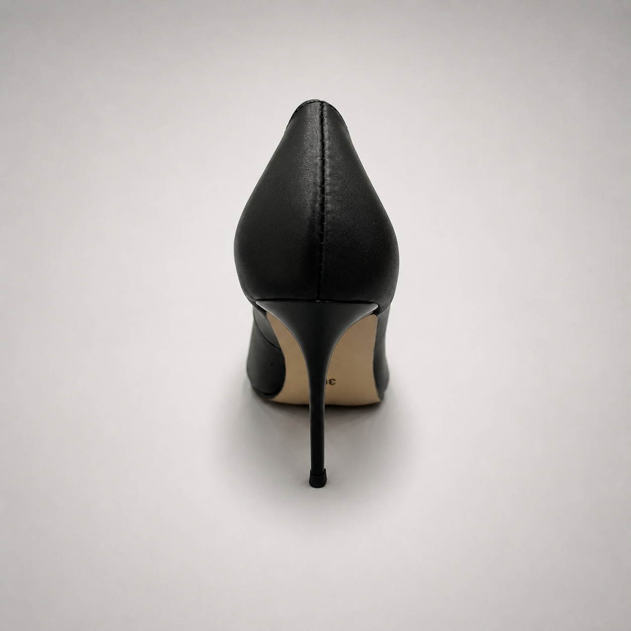 Black pump rear view showing a pointed toe