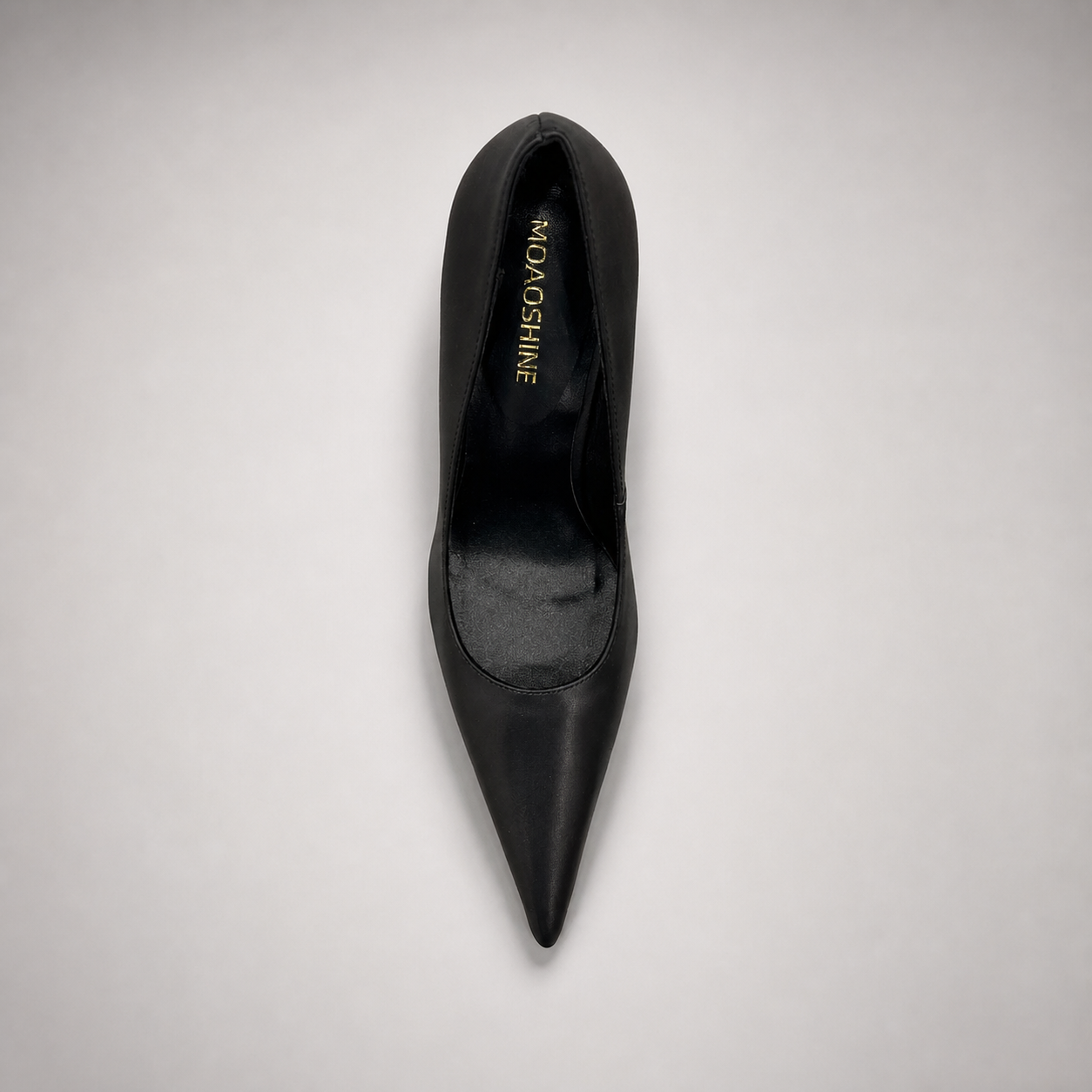 Black pump top view showing a pointed toe