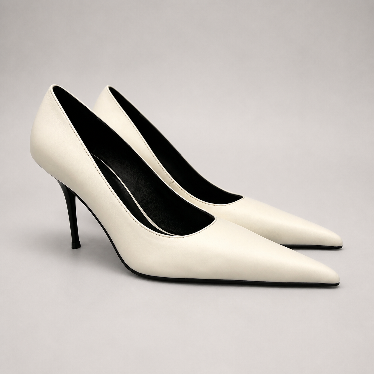 White pump pair three-quarter view showing a pointed toe