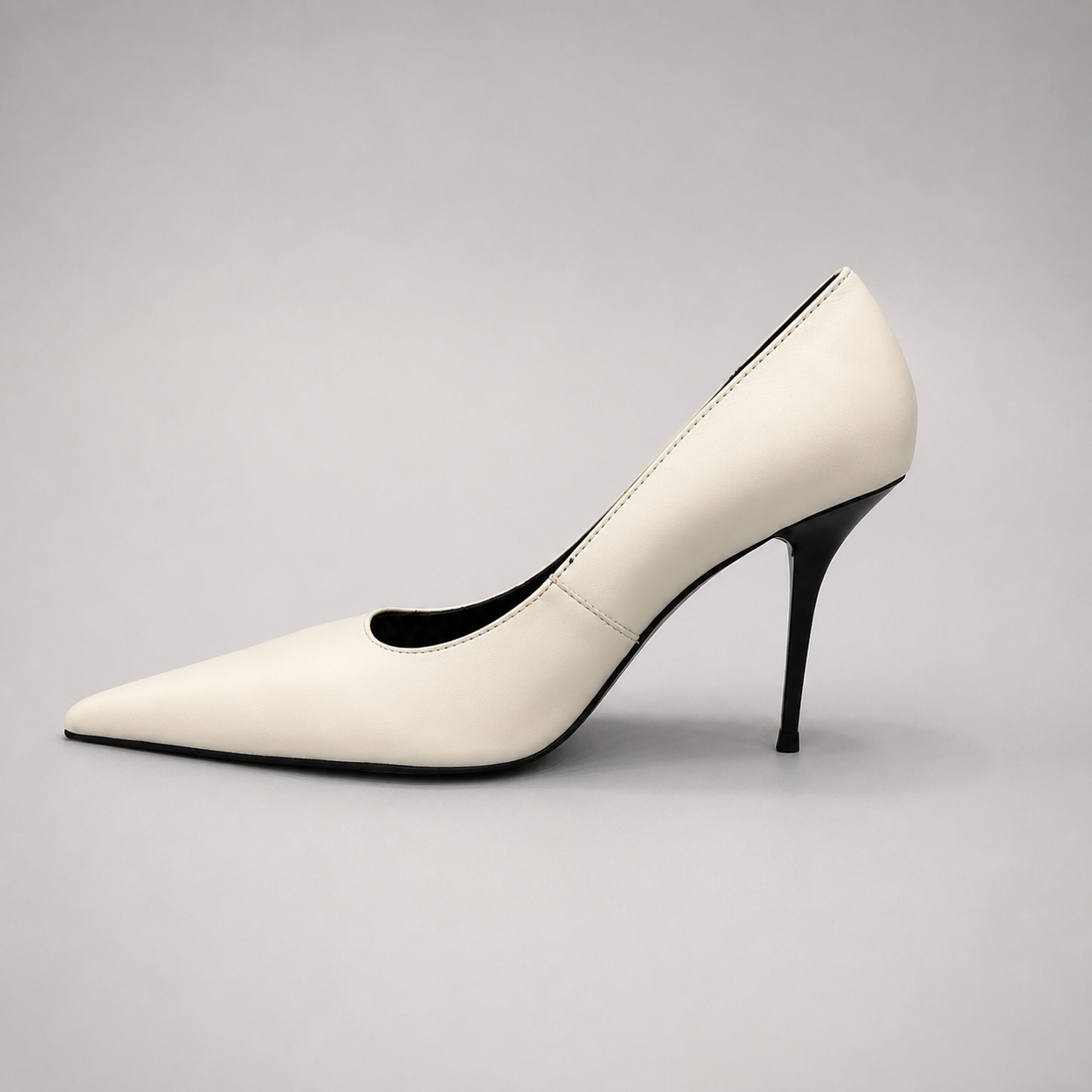 White pump opposite side profile showing a pointed toe