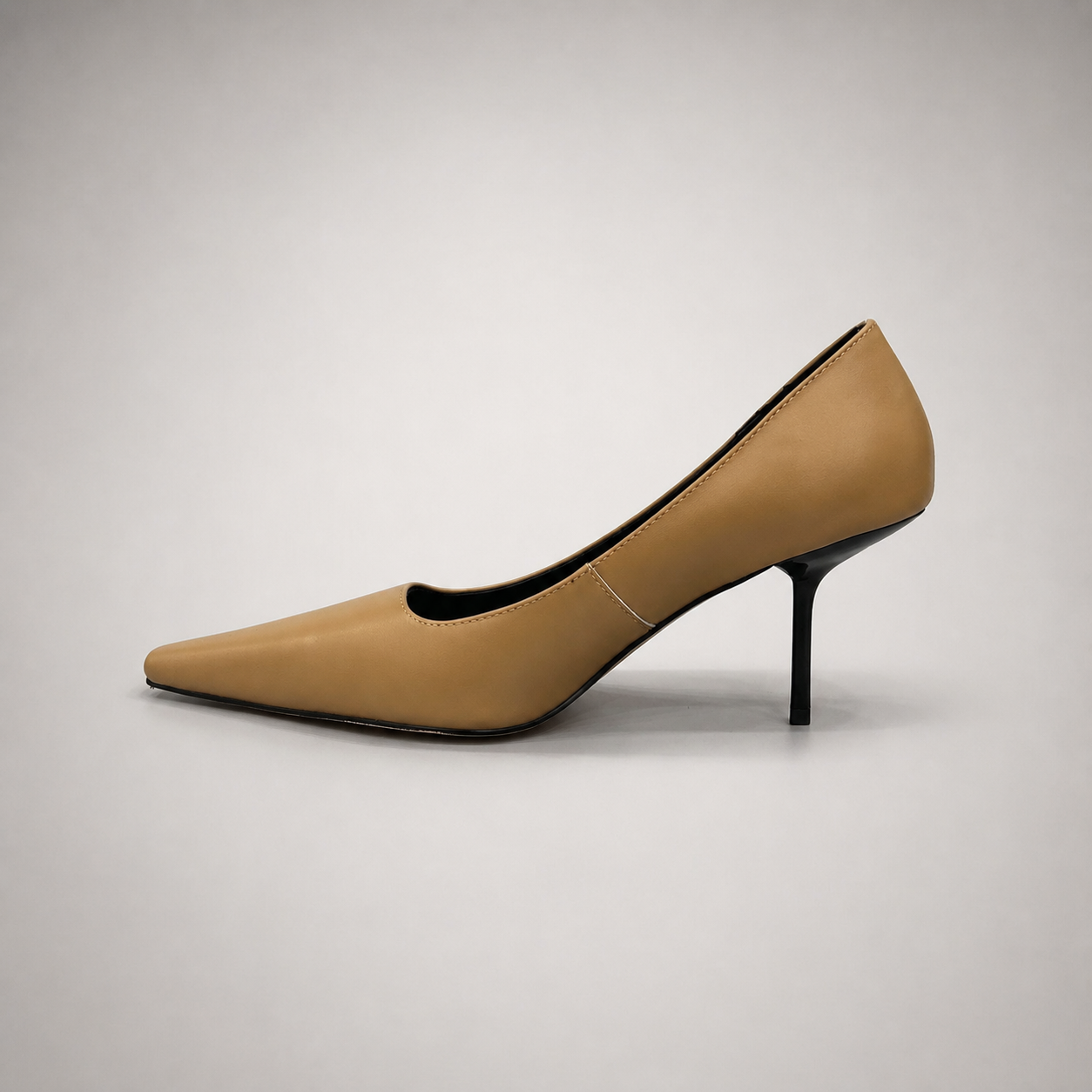 Tan pump opposite side profile showing a pointed toe