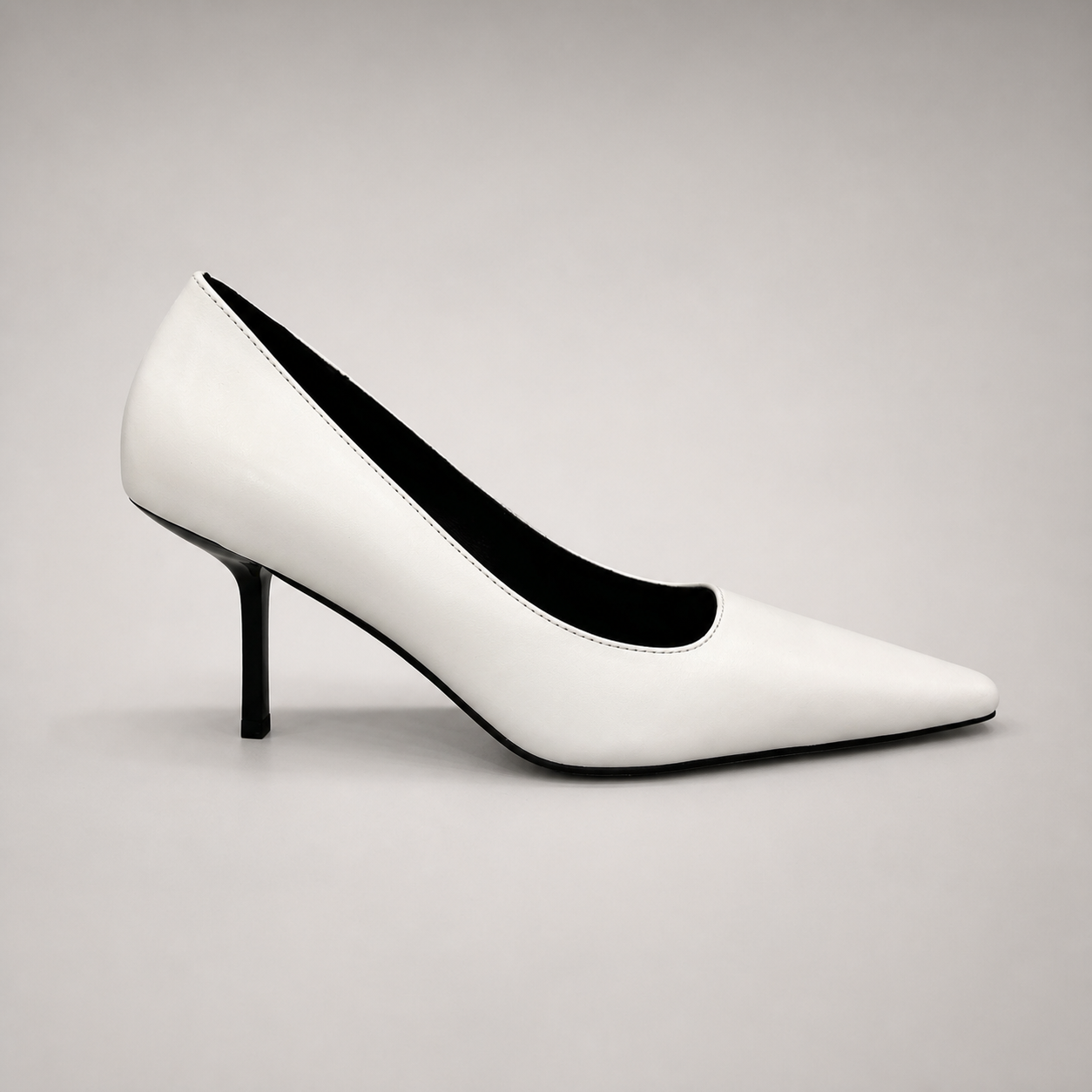 White pump side profile showing a pointed toe