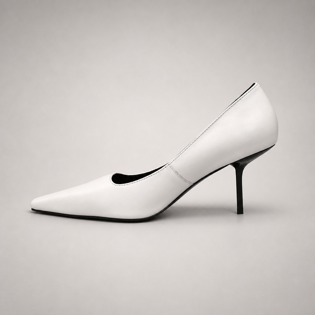 White pump opposite side profile showing a pointed toe