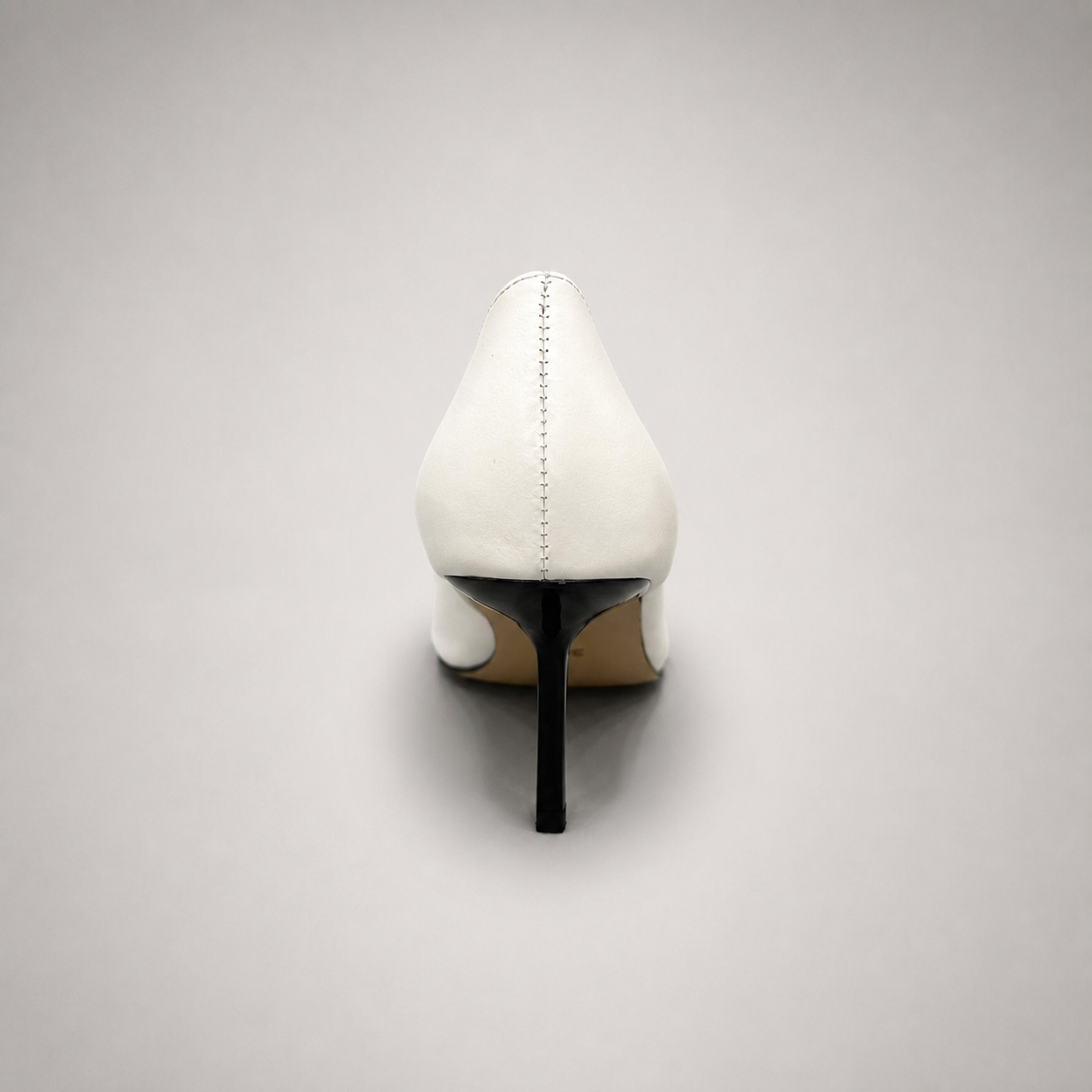 White pump rear view showing a pointed toe