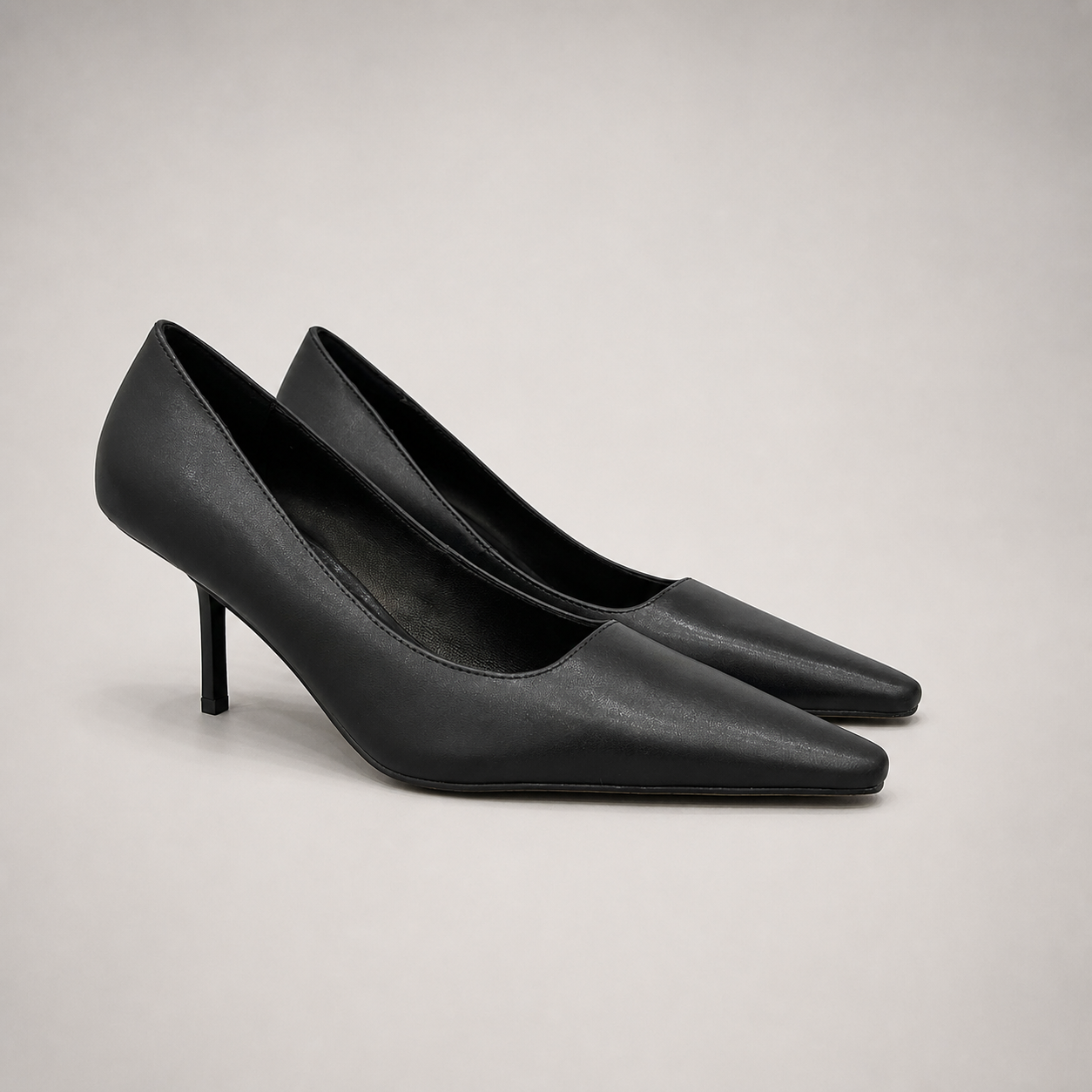 Black pump pair three-quarter view showing a pointed toe