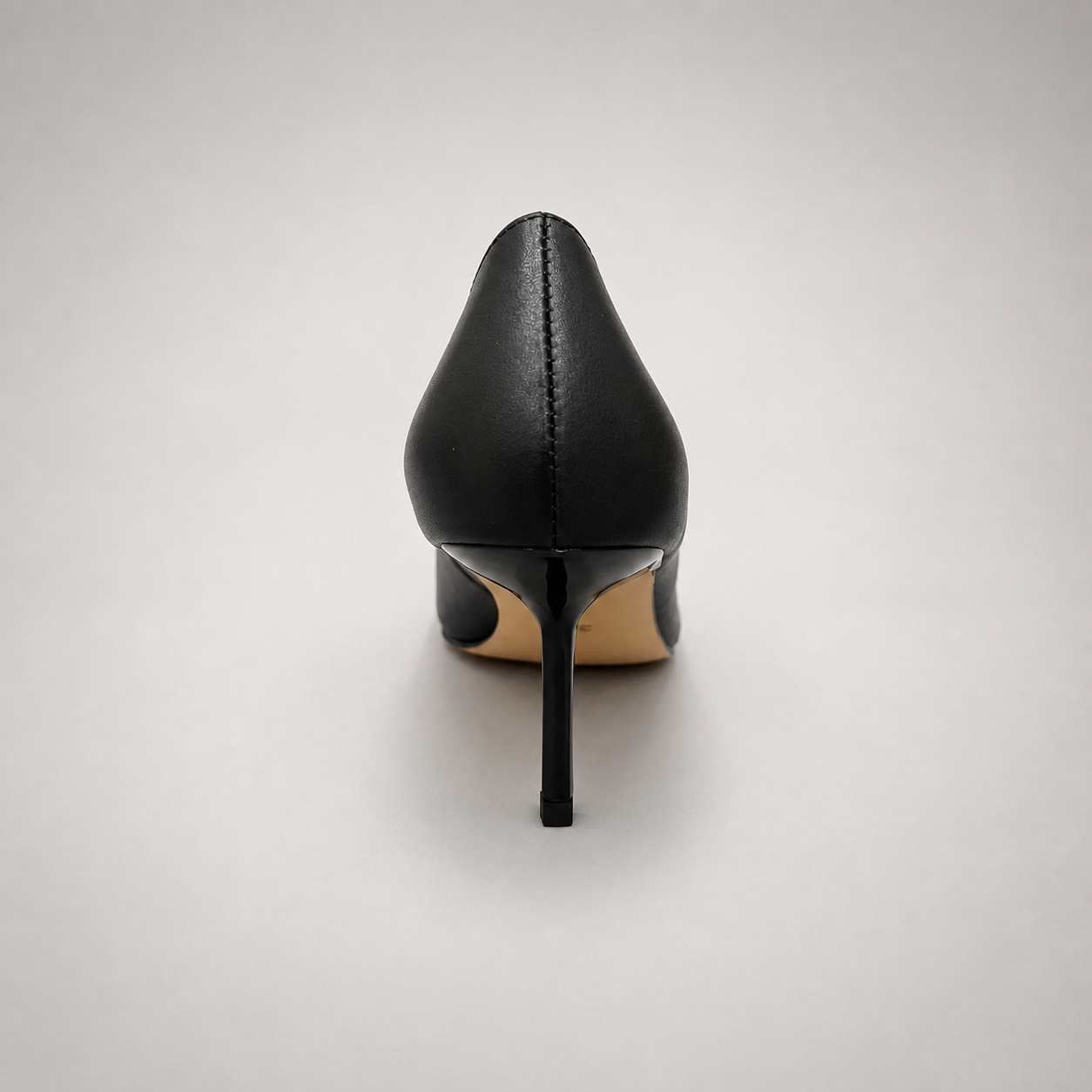 Black pump rear view showing a pointed toe