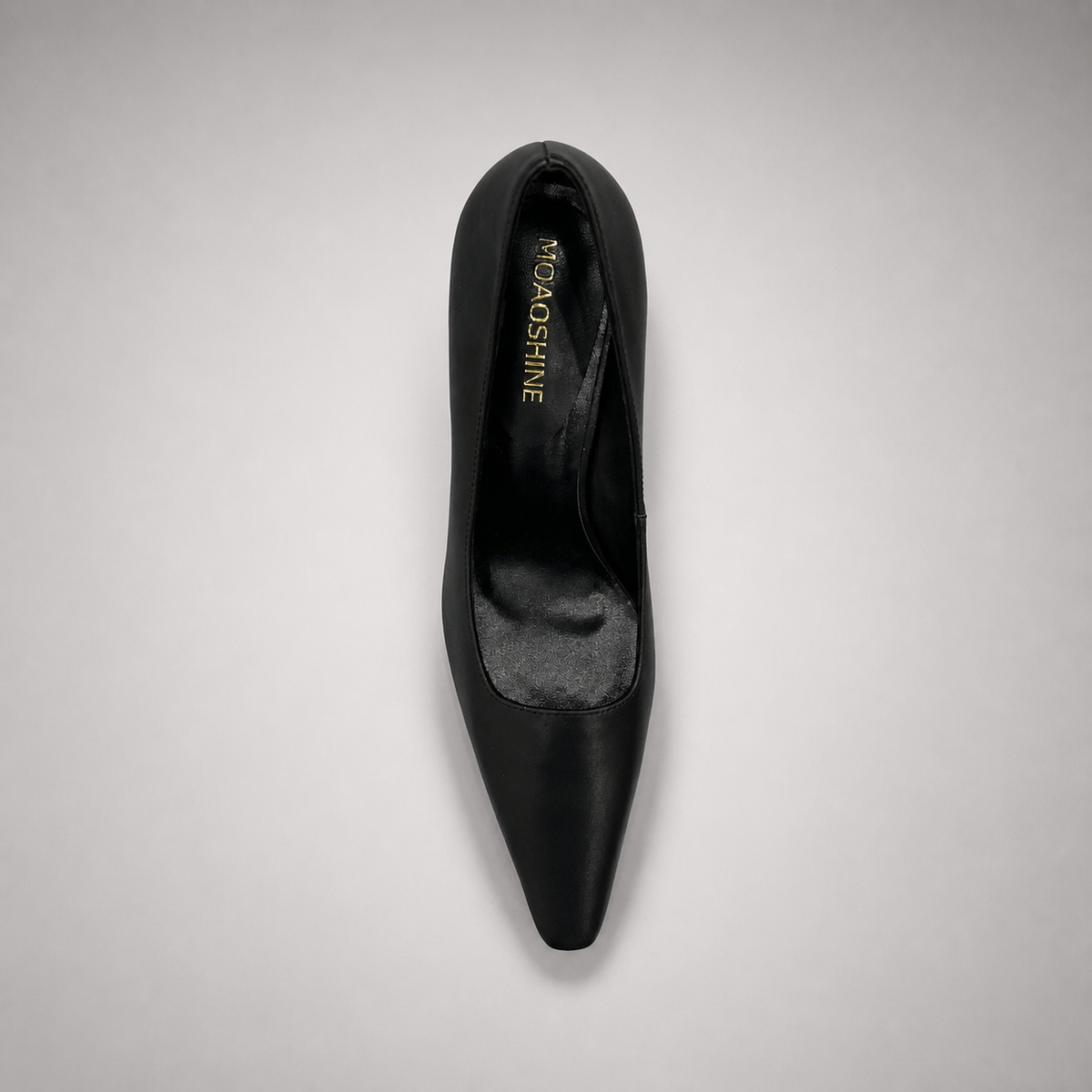 Black pump top view showing a pointed toe
