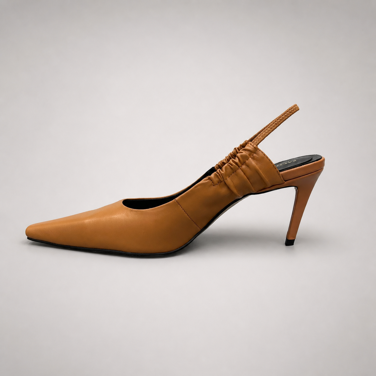Tan slingback pump opposite side profile showing a pointed toe and gathered slingback strap