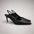 Black slingback pump pair three-quarter view showing a pointed toe
