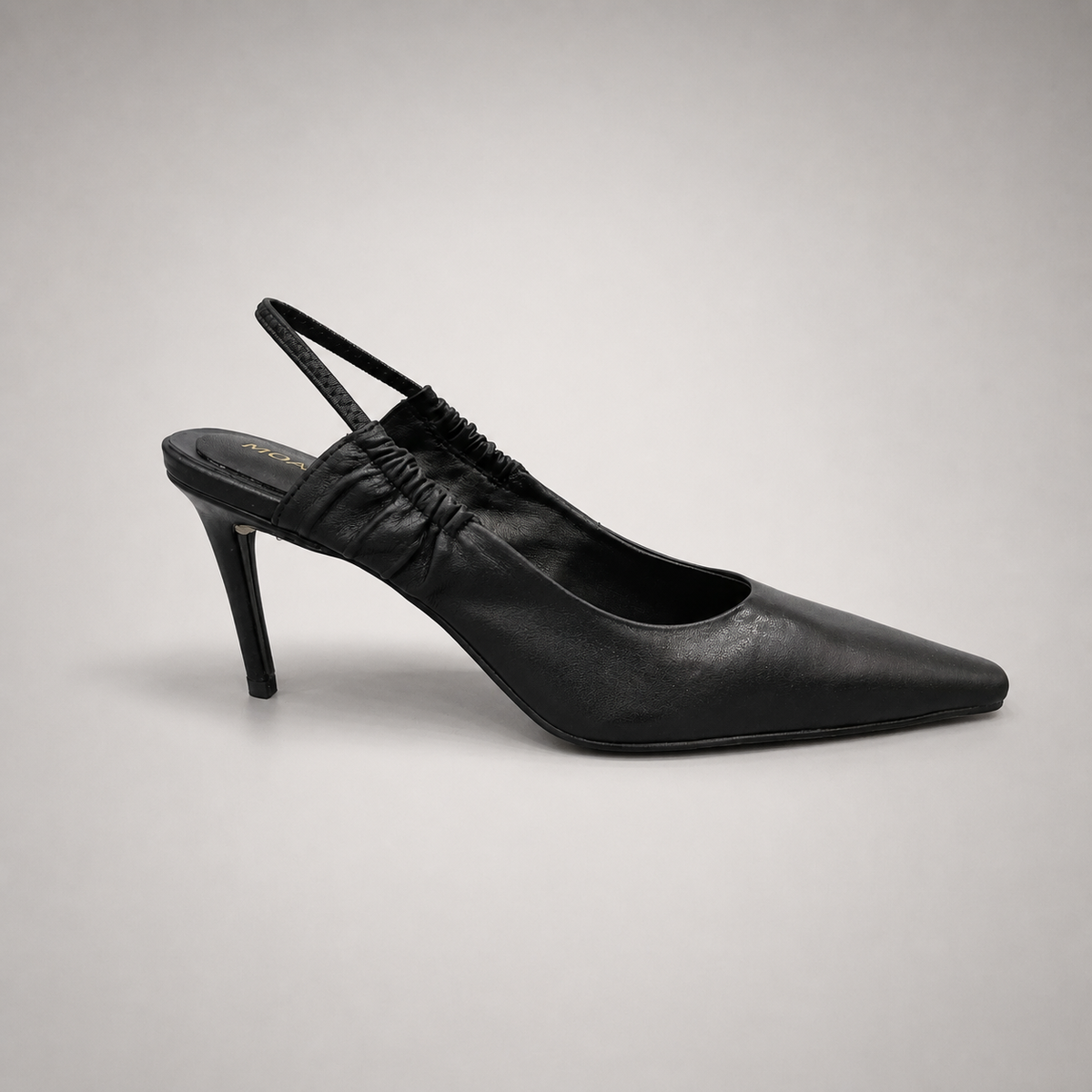 Black slingback pump side profile showing a pointed toe
