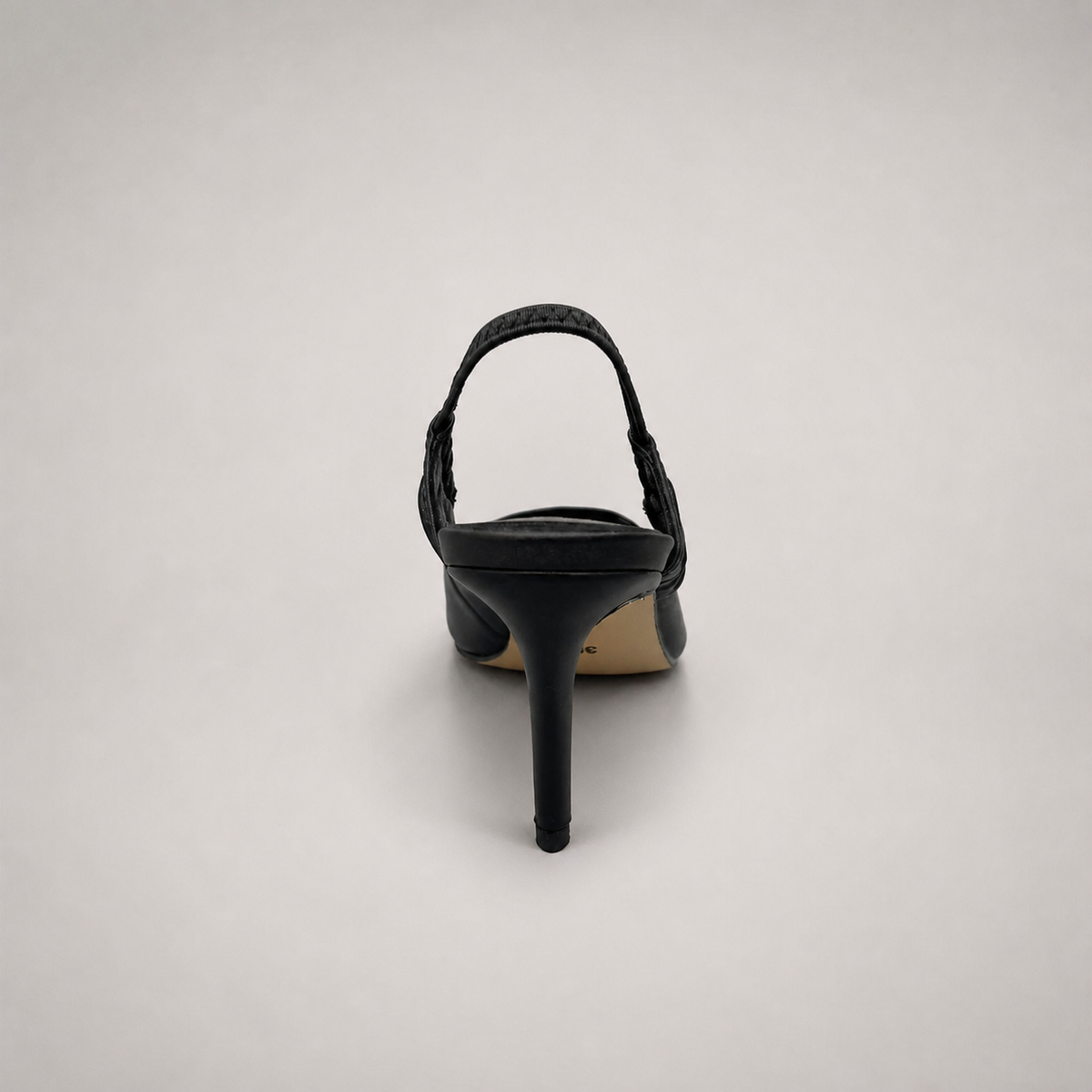 Black slingback pump rear view showing a pointed toe