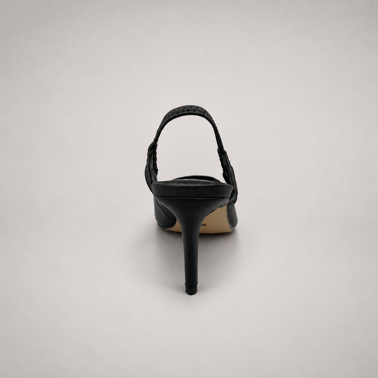 Black slingback pump rear view showing a pointed toe