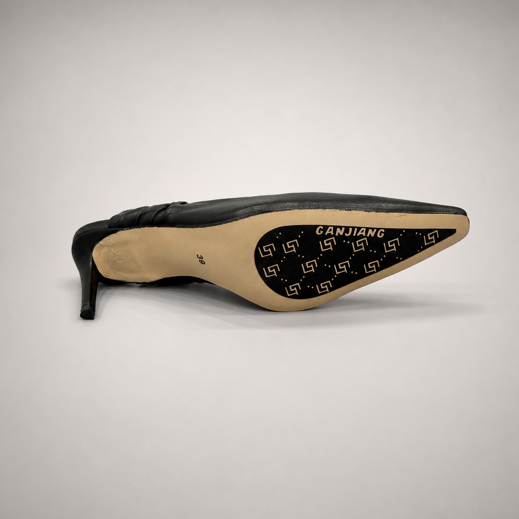 Black slingback pump outsole view showing the cow leather outsole