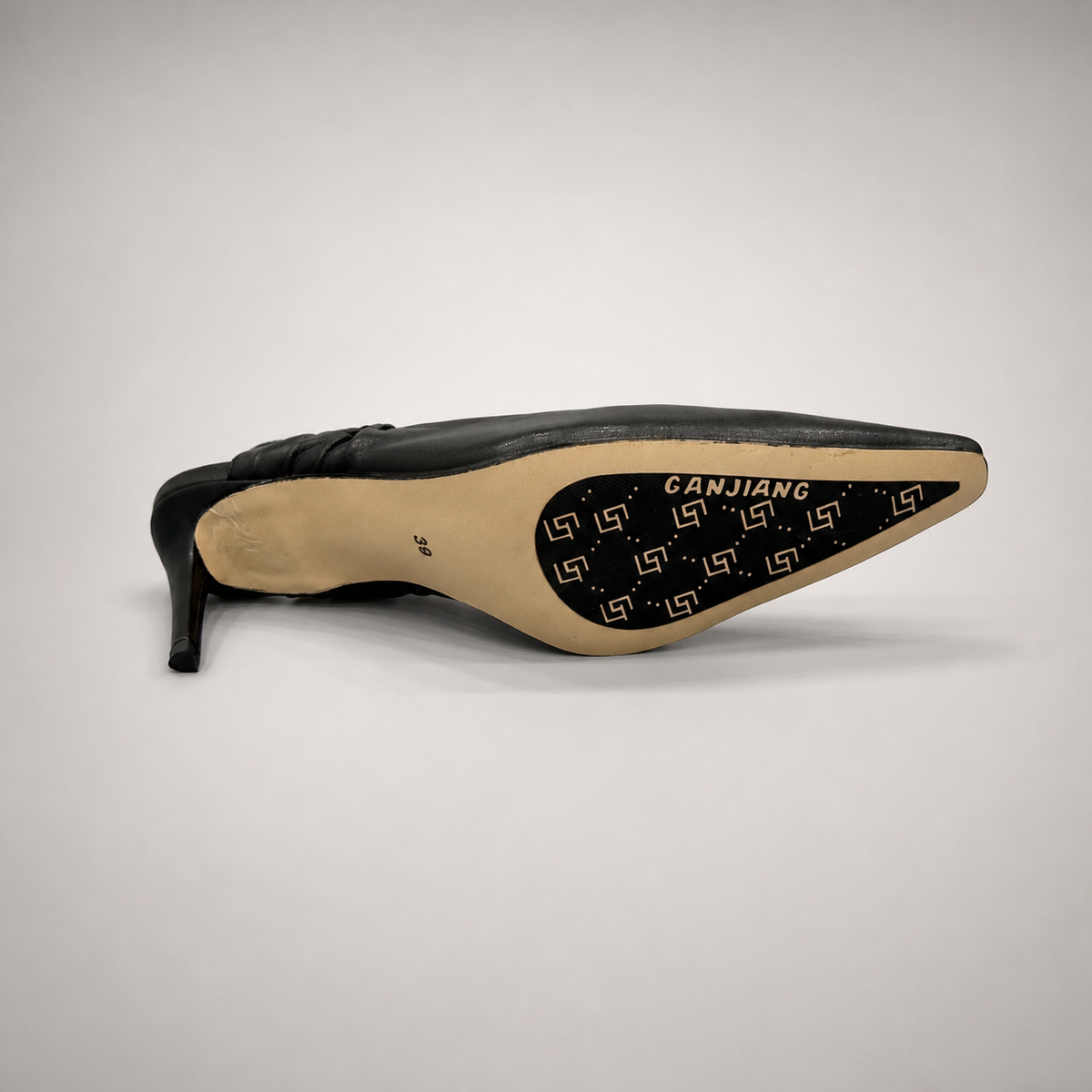 Black slingback pump outsole view showing the cow leather outsole